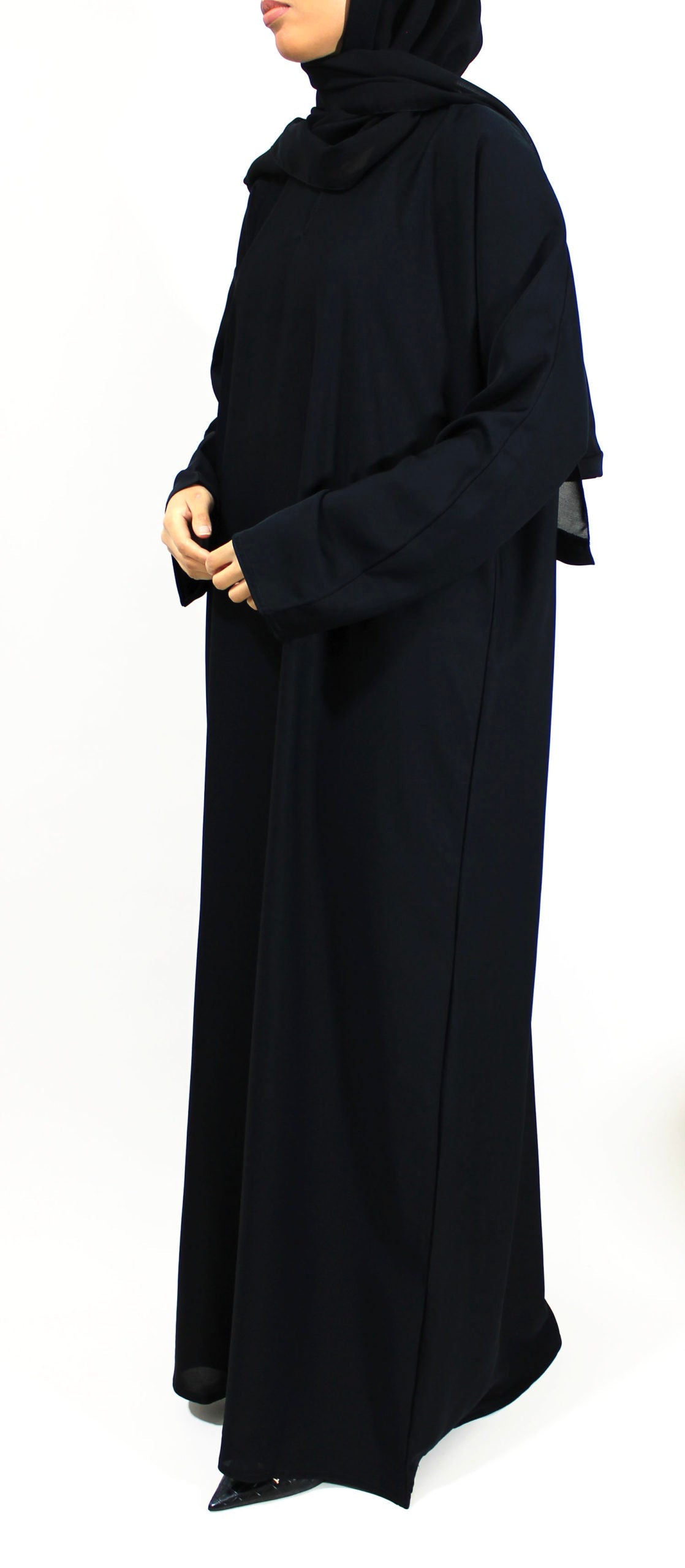 Plain black everyday abaya showing a simple full-length cut for Hajj preparation