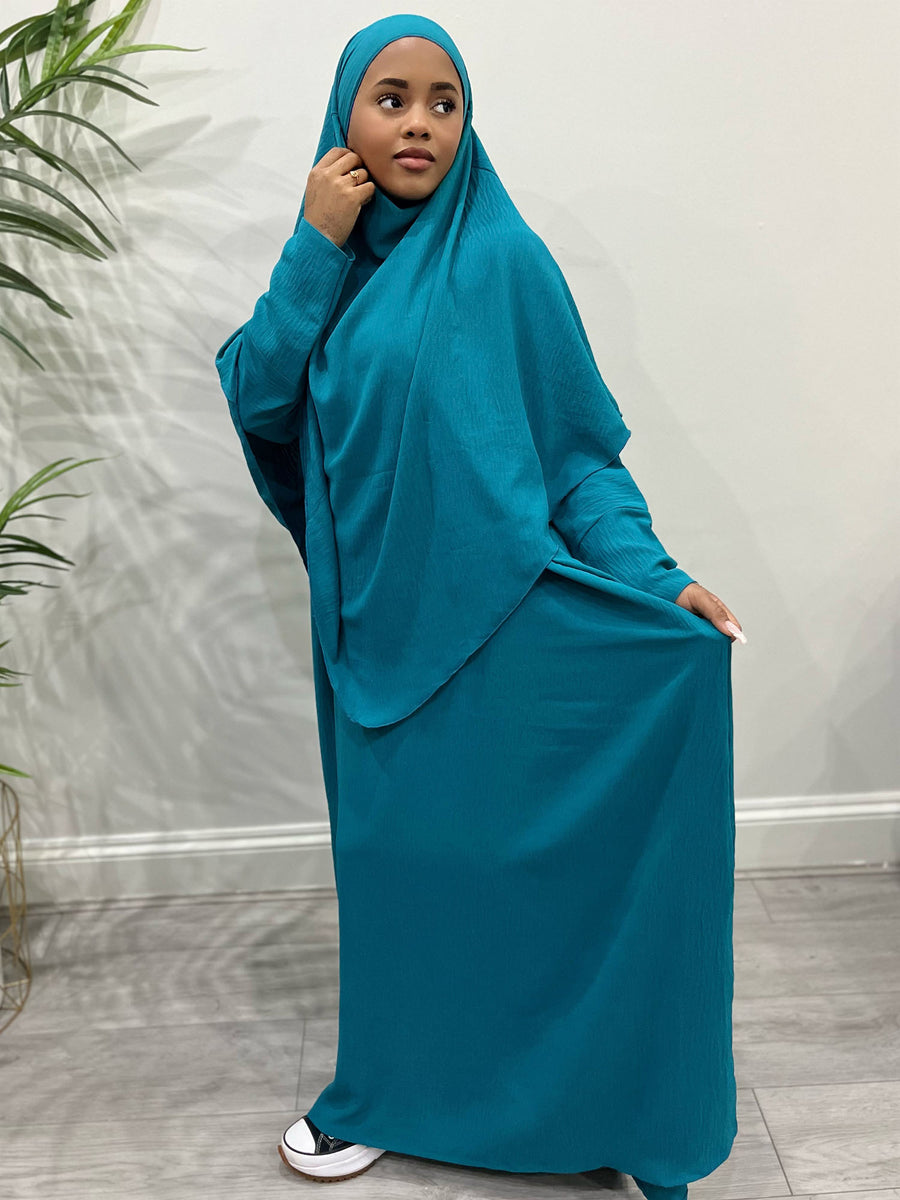 Dark turquoise overhead abaya showing the loose fit and crepe drape