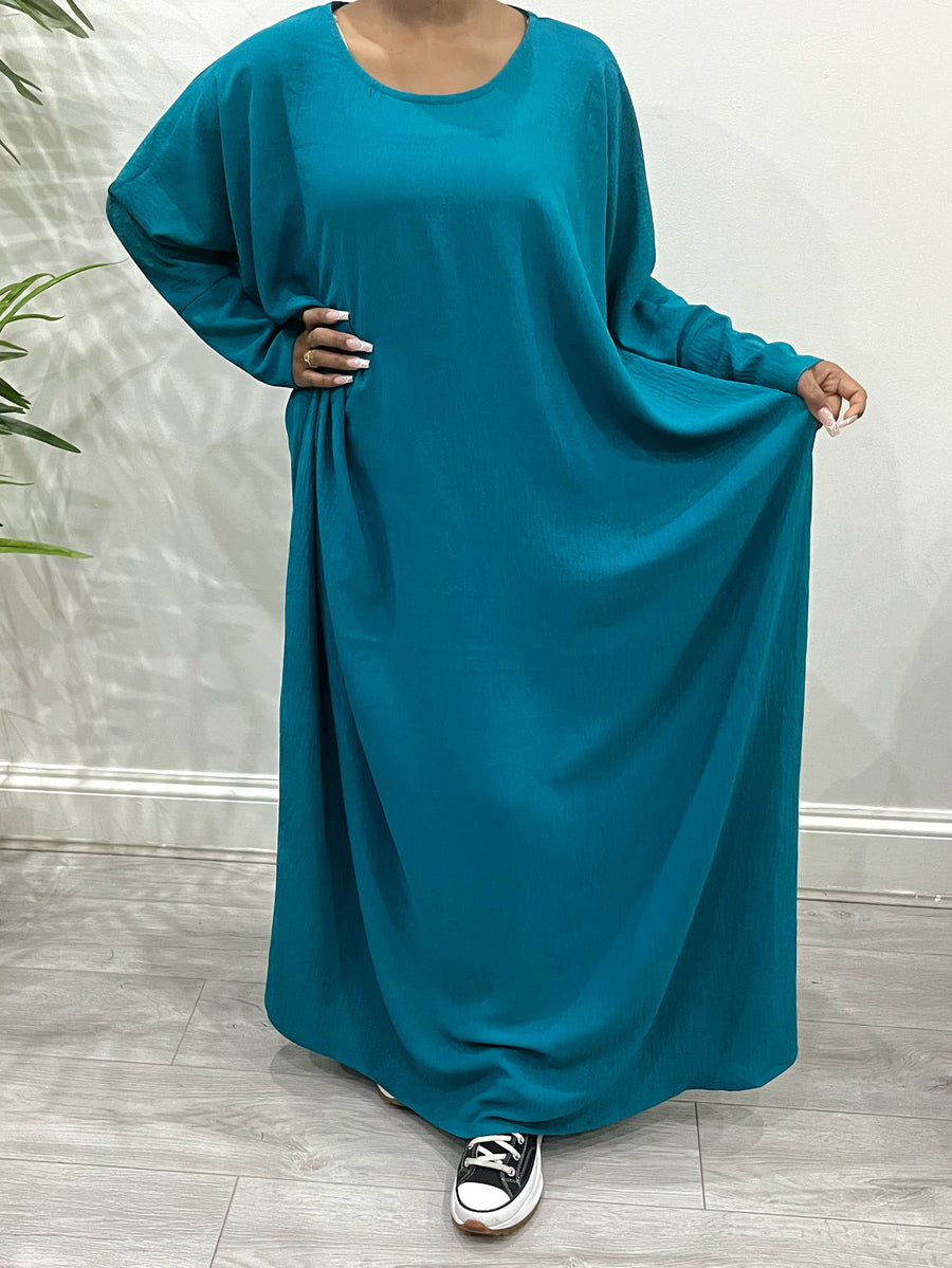Dark turquoise diamond-shaped khimar showing full chest coverage