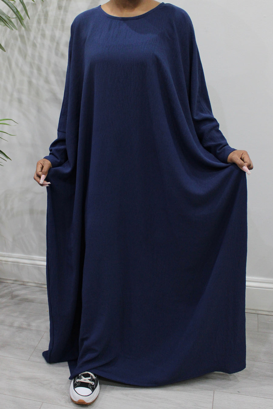Navy overhead abaya showing the loose fit and crepe drape