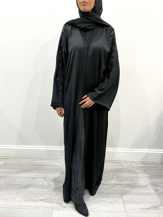 Amani's black open abaya with leaf-shaped beaded embellishment, front view