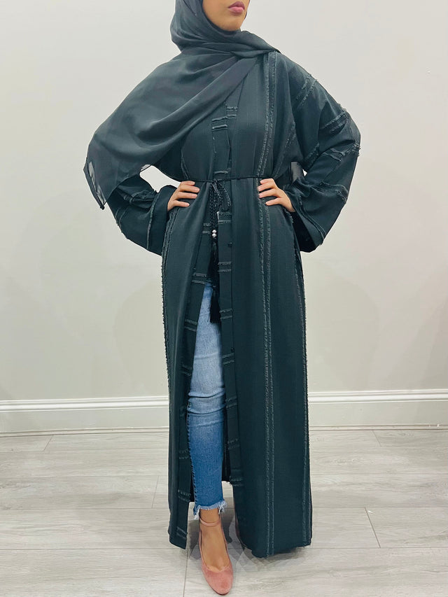 Amani's black open abaya worn closed and belted, front view