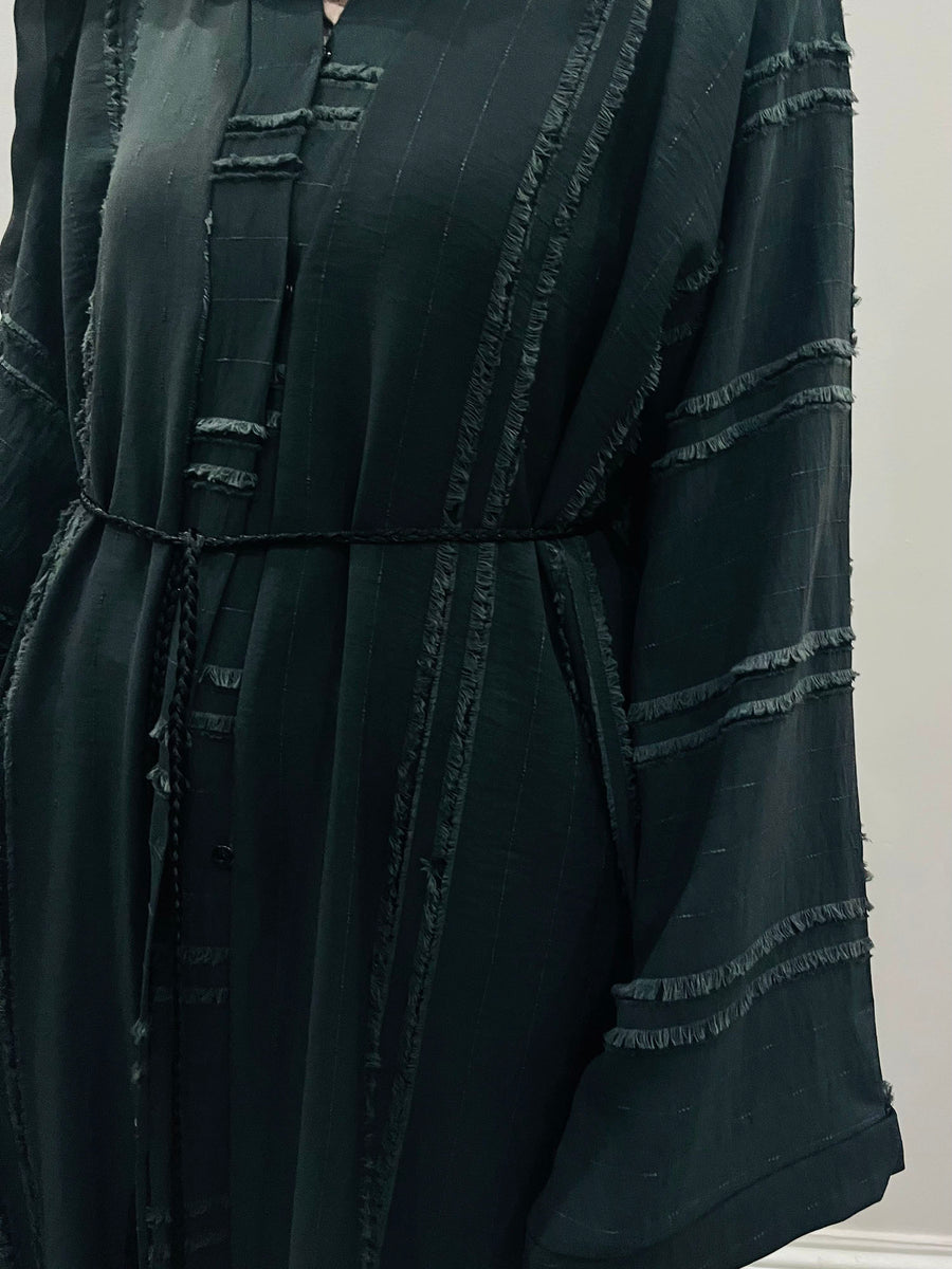 Detail of the black abaya press-stud fastenings and matching belt