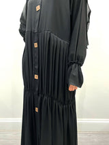 Amani's black pleated open abaya front view showing all-over pleating