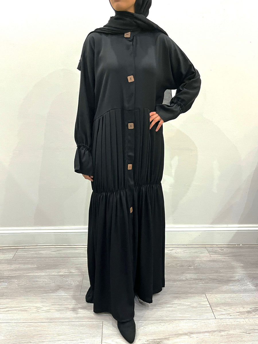 Black pleated open abaya worn open as a layer
