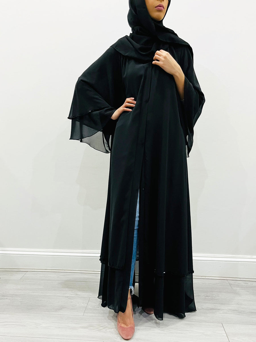 Black-on-black chiffon abaya belted at the waist