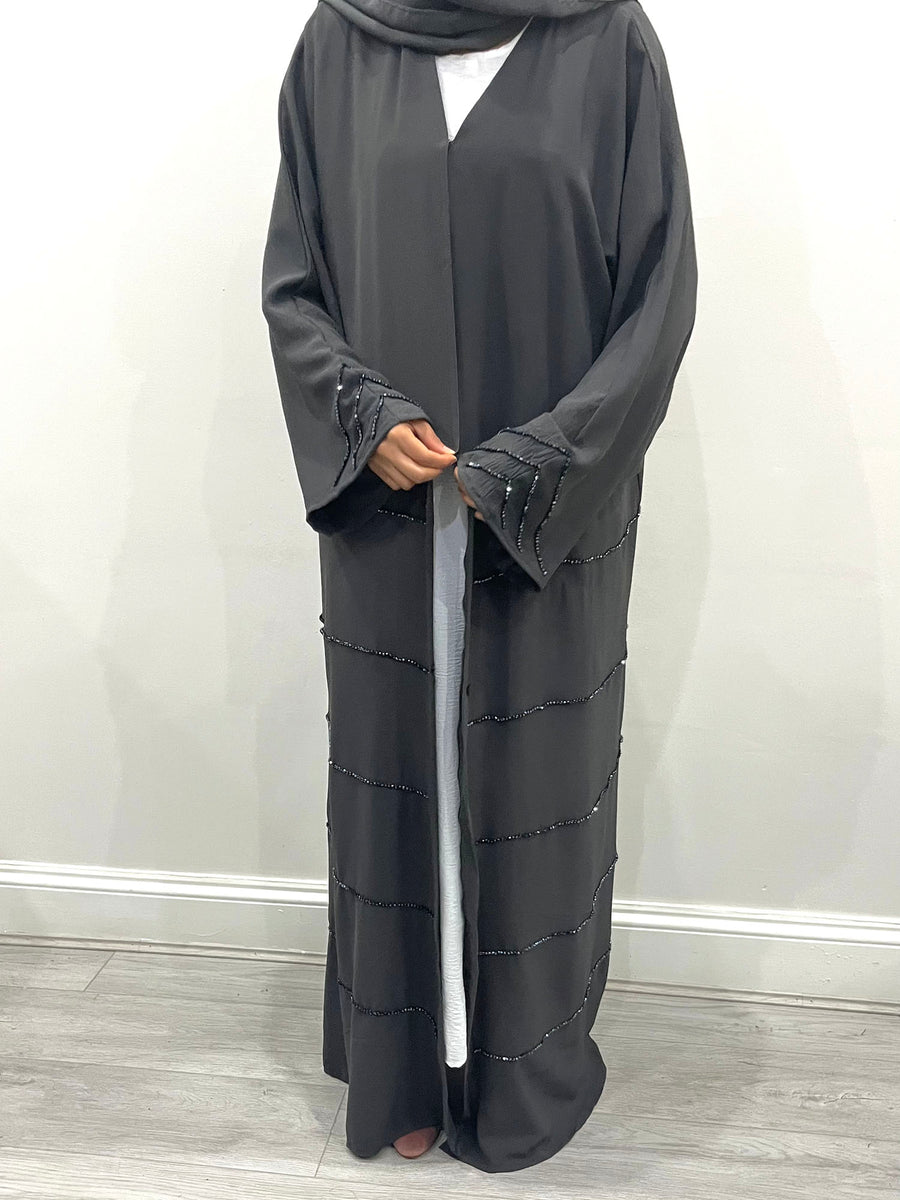 Charcoal grey abaya showing hand-stitched beaded embellishment