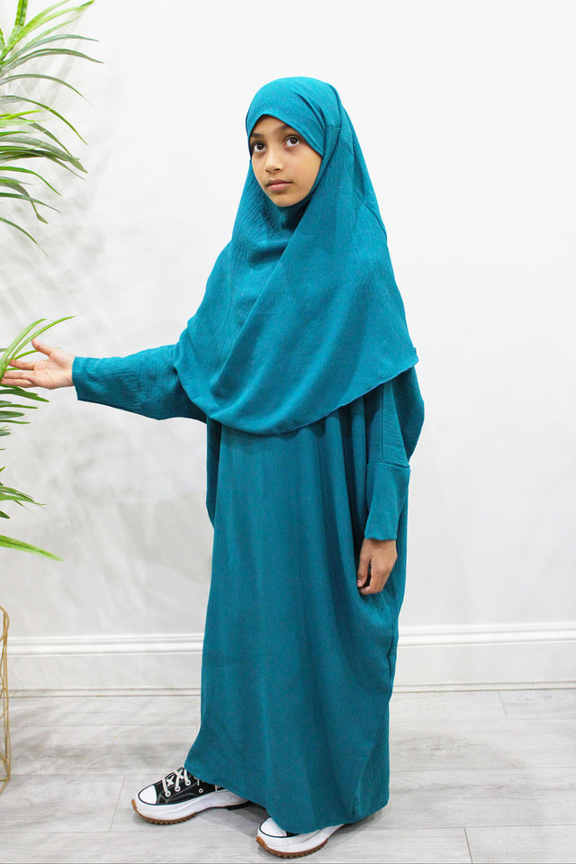 Girl wearing Amani's dark turquoise abaya and khimar set, front view