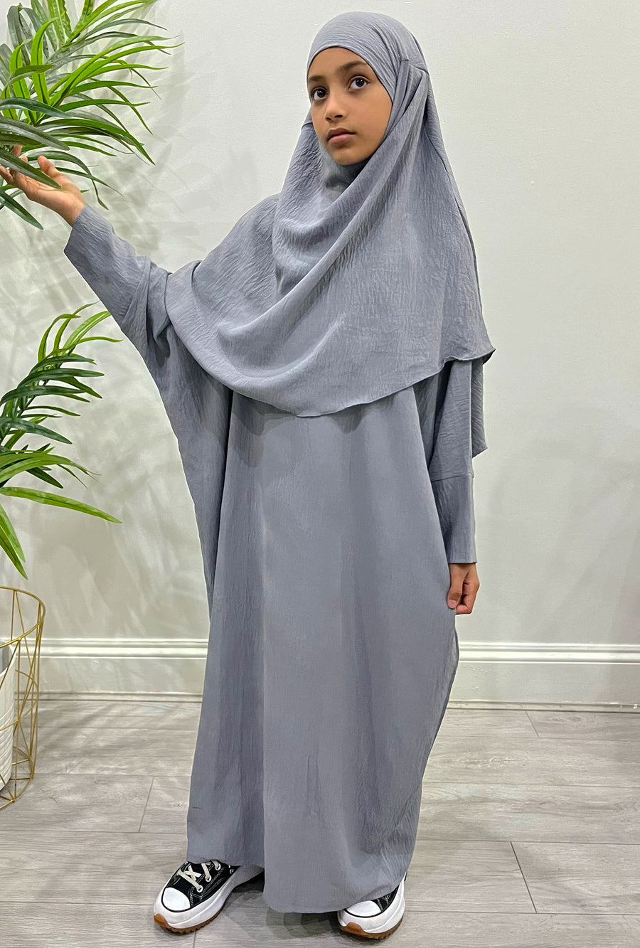 Girl wearing Amani's grey abaya and khimar set, front view