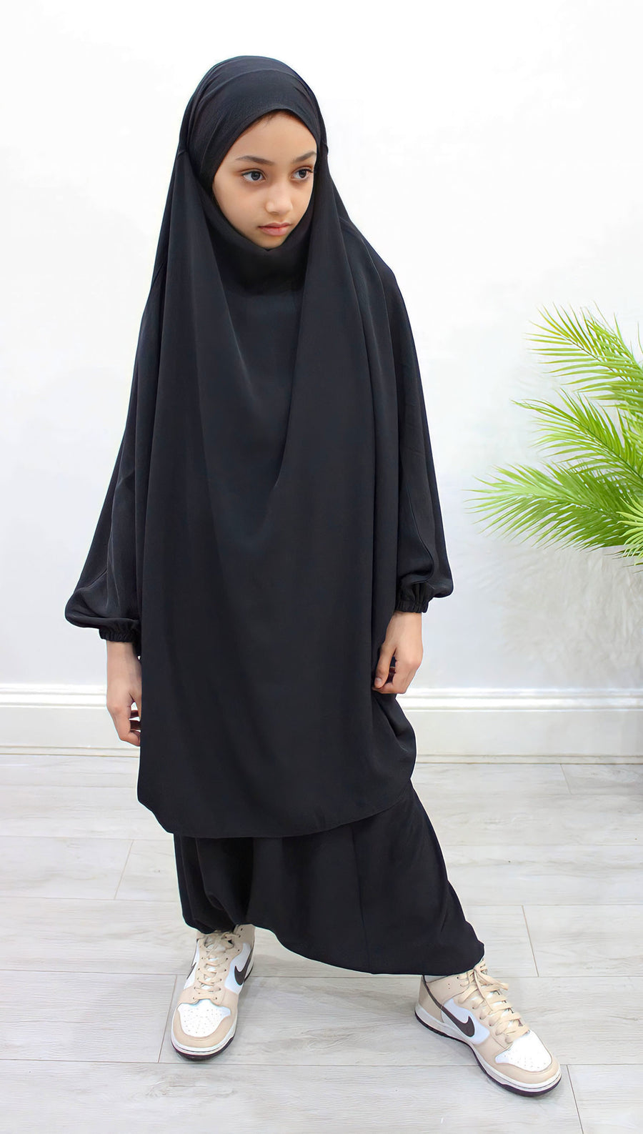 Girl wearing Amani's black two-piece sarouel jilbab with half-jilbab top and harem trousers