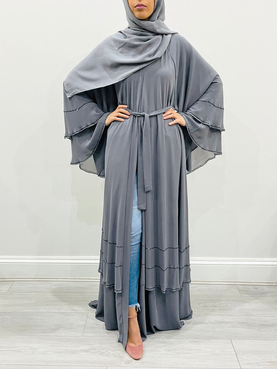 Close-up of the black beadwork on the grey chiffon abaya
