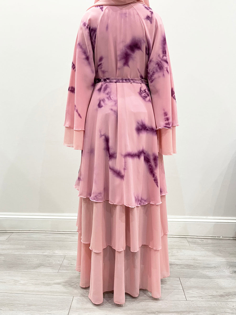 Pink lemonade tie-dye abaya shown with its matching hijab and belt