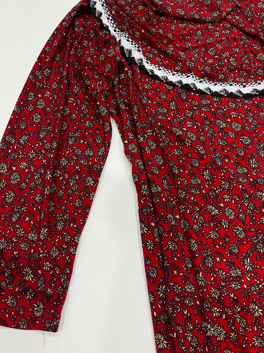 Little girl wearing Amani's red one-piece slip-on prayer dress with attached hijab