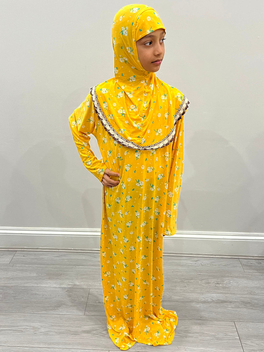 Little girl wearing Amani's Tuscany yellow one-piece slip-on prayer dress with attached hijab