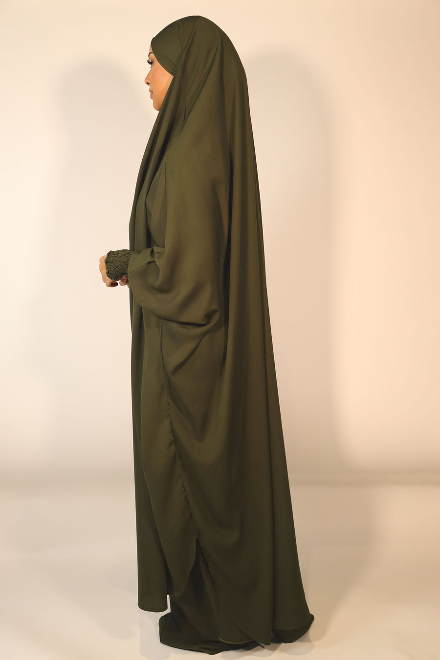 Dark green jilbab set showing the overhead top with longer back and ruched cuffs