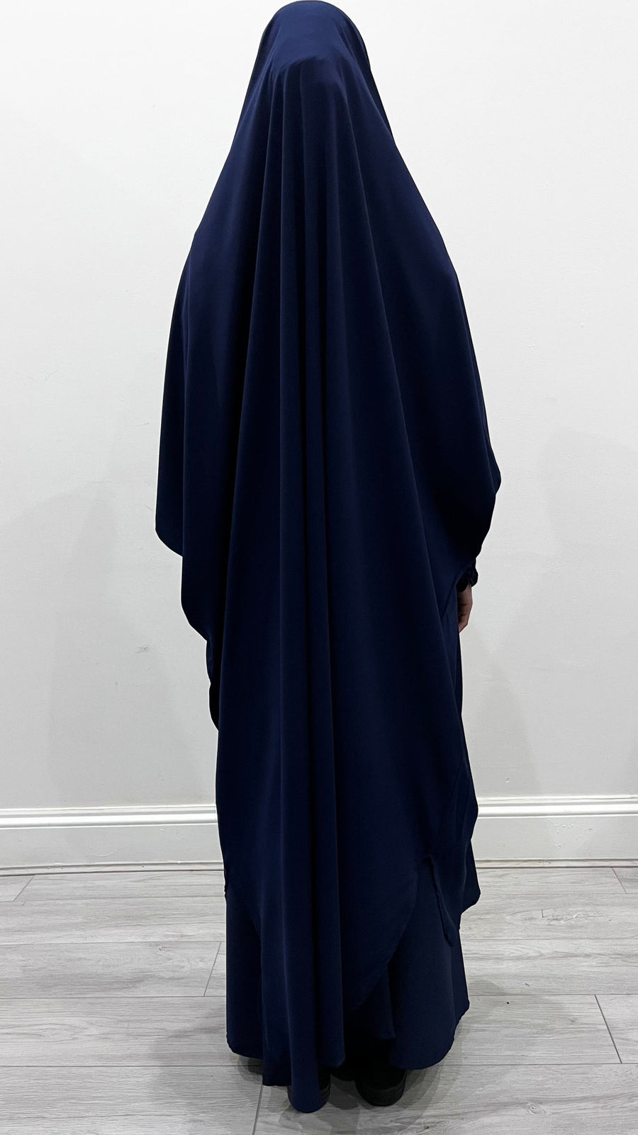 Navy blue jilbab set showing the overhead top with longer back and ruched cuffs