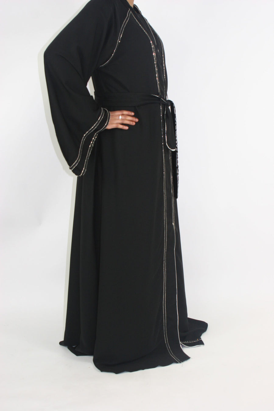 Silver-bordered abaya showing the A-line cut and bell sleeves