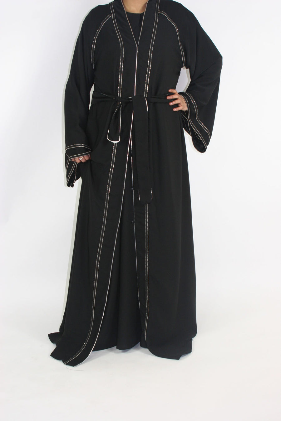 Open abaya with silver borders layered over an outfit