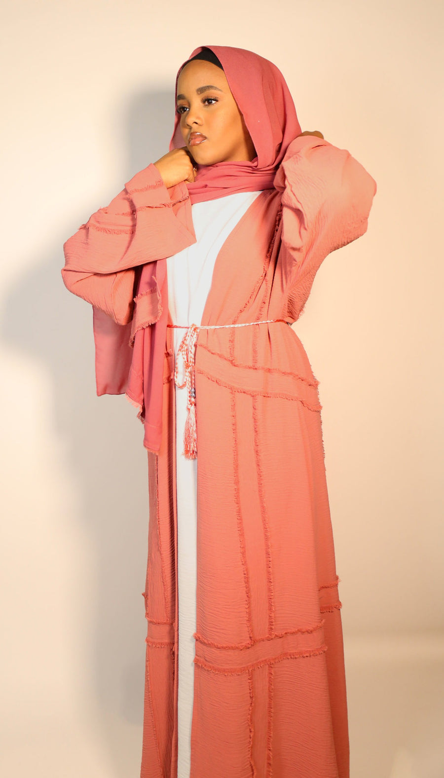 Dark salmon abaya shown with its matching hijab and belt