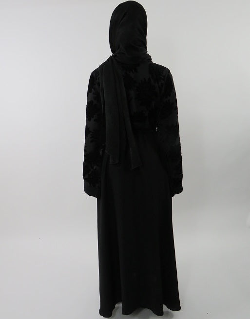 Close-up of tonal floral velvet texture on black abaya