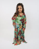 Girl wearing Amani's green floral print long-sleeve kids maxi dress with belt