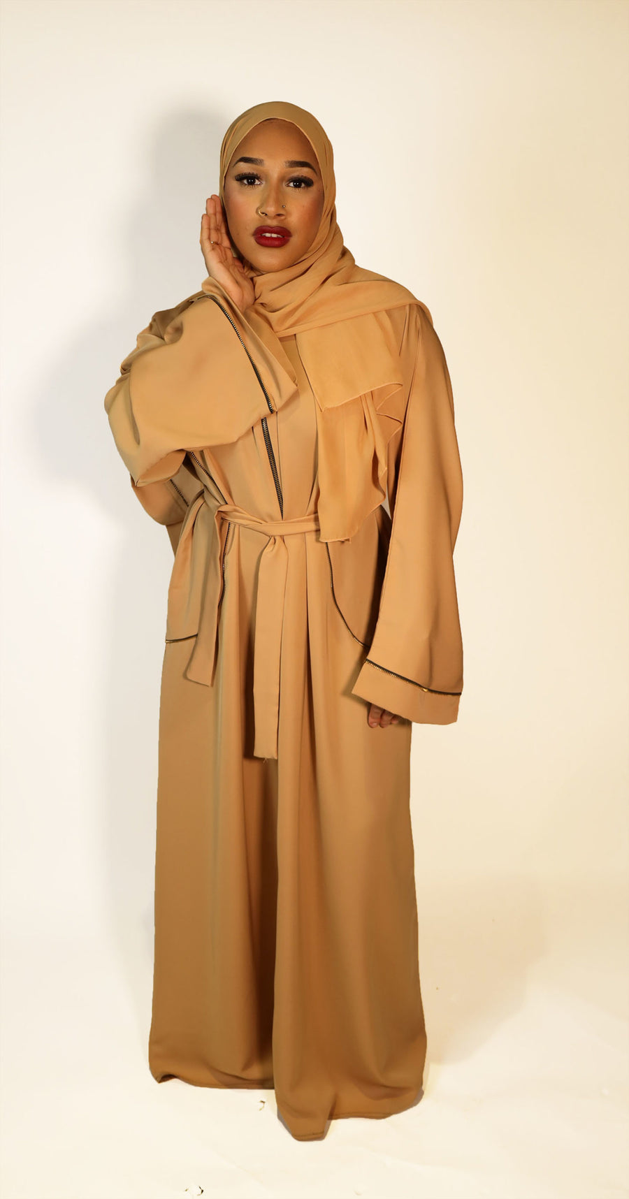 Gold long open abaya jacket layered over an outfit