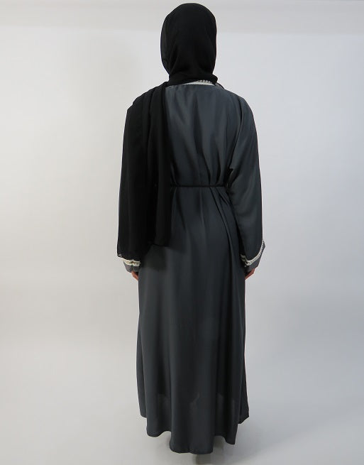 Full-length view of the grey two-tone pearl embellished abaya