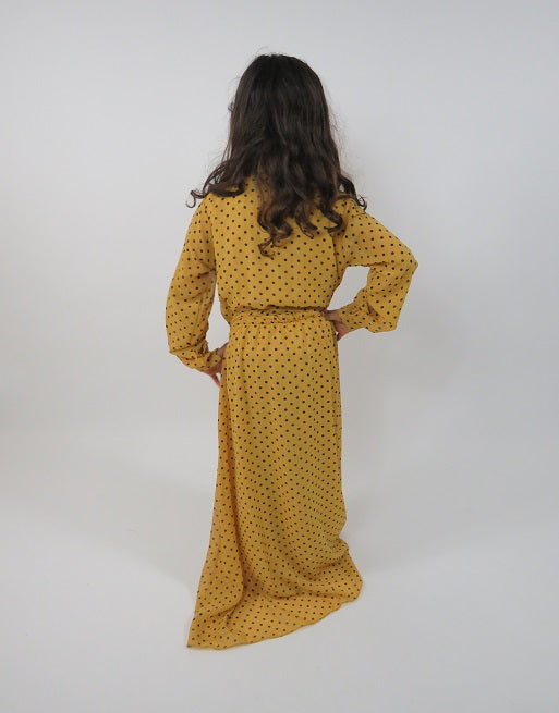 Full-length view of Amani's yellow polka-dot kids maxi dress with belt
