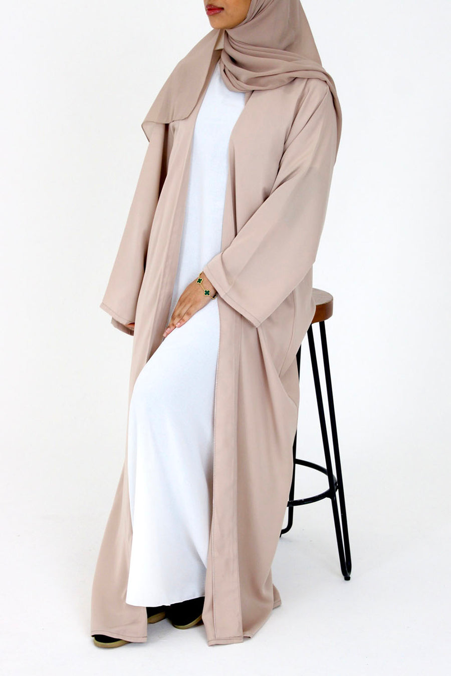 Beige duster-style open abaya worn open over an outfit, front view