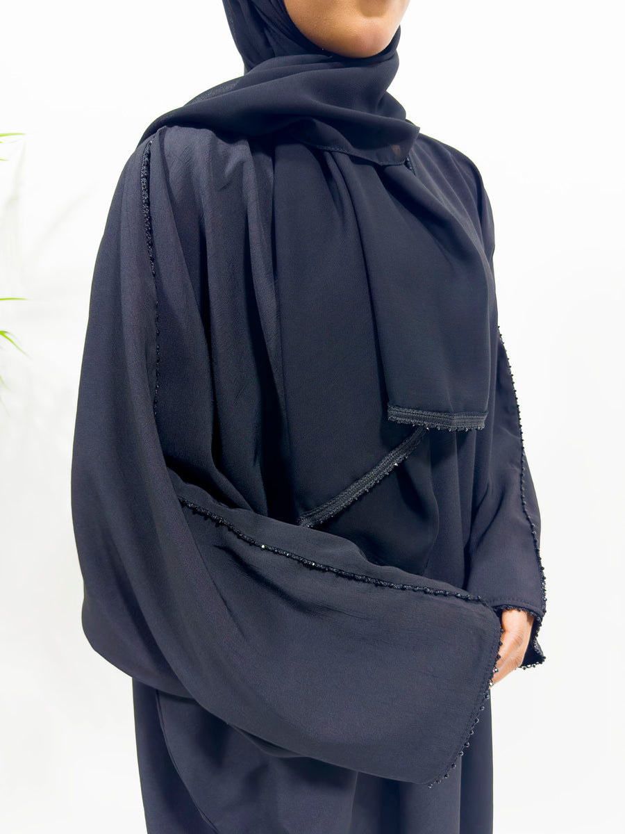 Close view of the black embellished detailing on the ash black abaya