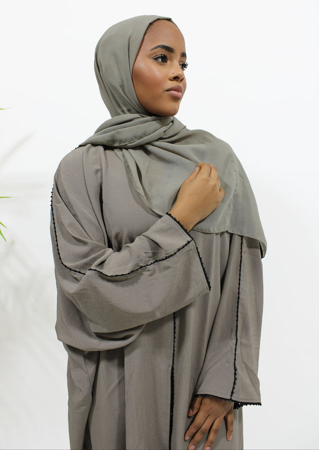 Taupe open abaya with black embellishment shown front-on with matching hijab