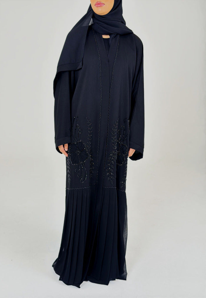Close-up of the tonal black beadwork on the open abaya