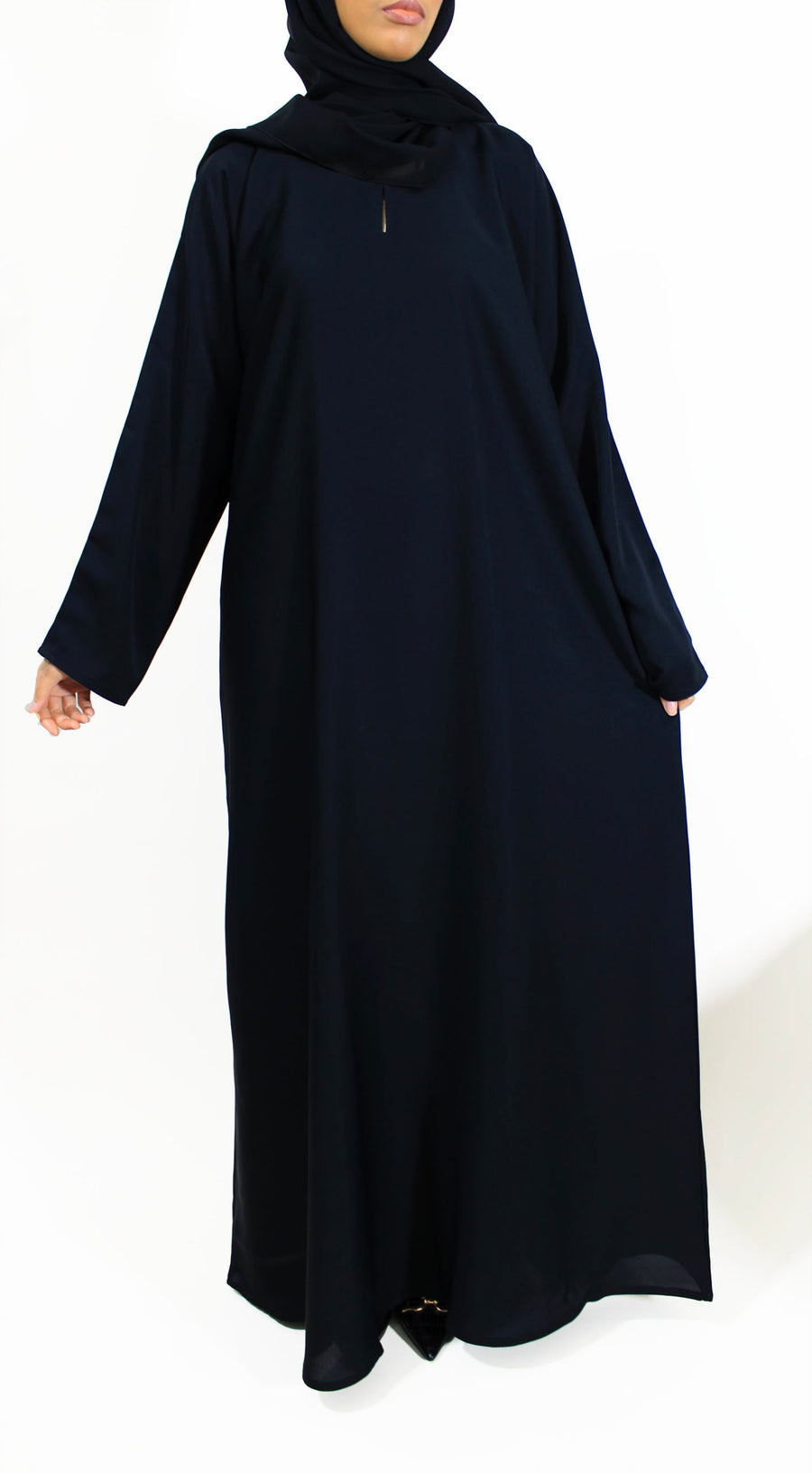 Black closed abaya showing round neck and A-line cut