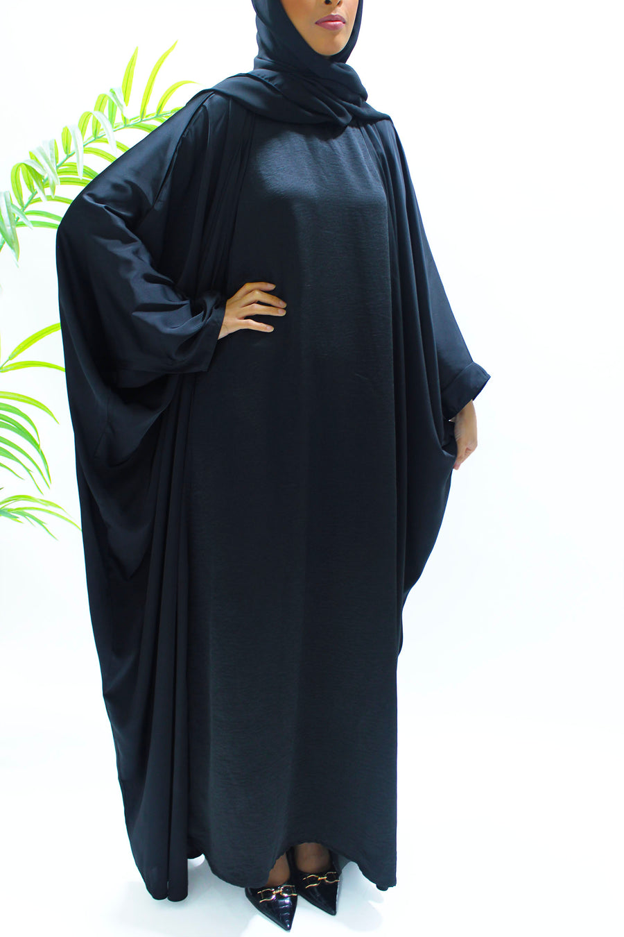 Woman wearing Amani's black farasha abaya set with matching hijab