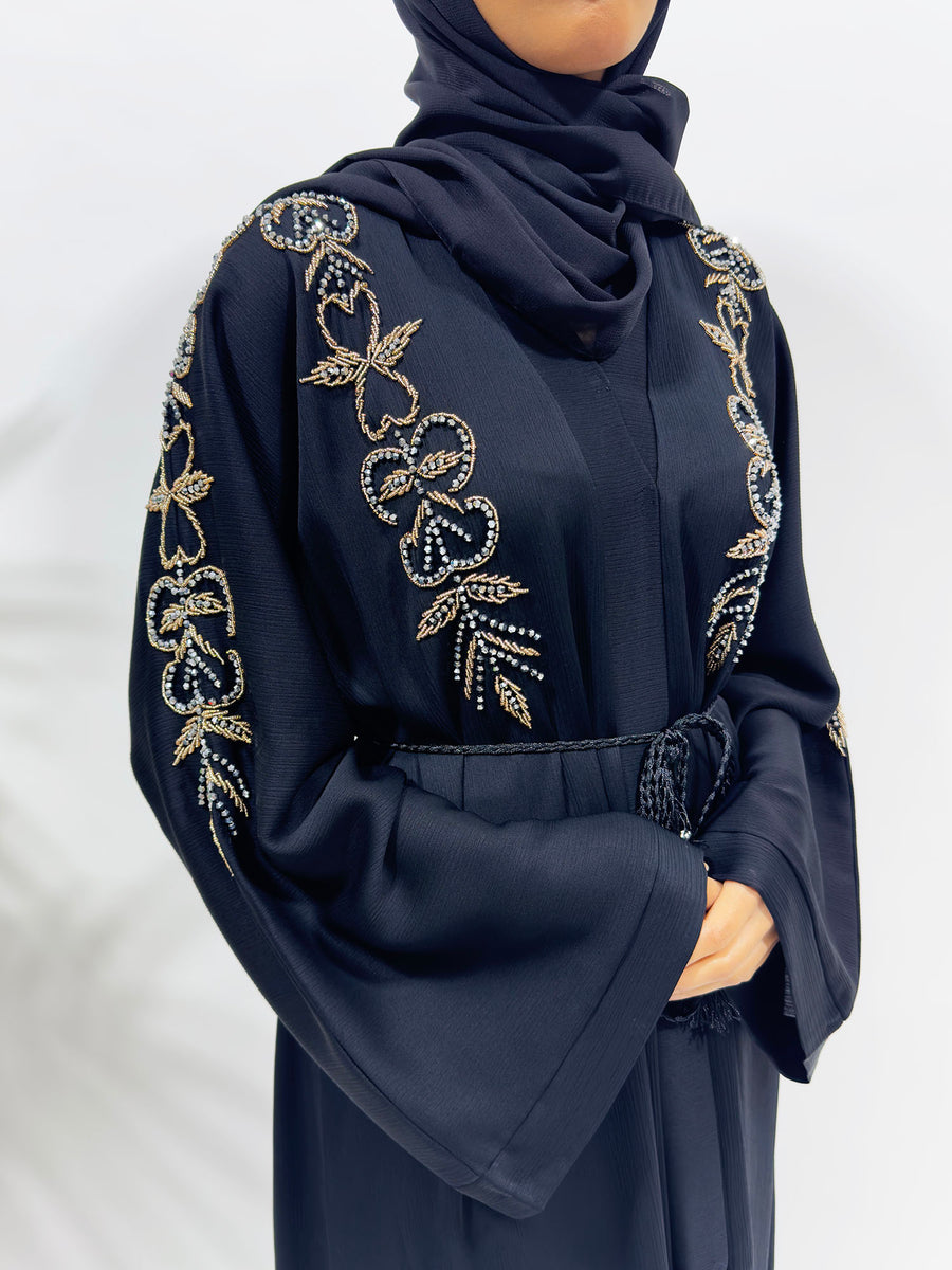 Close-up of the hand-stitched black and grey beading on the abaya