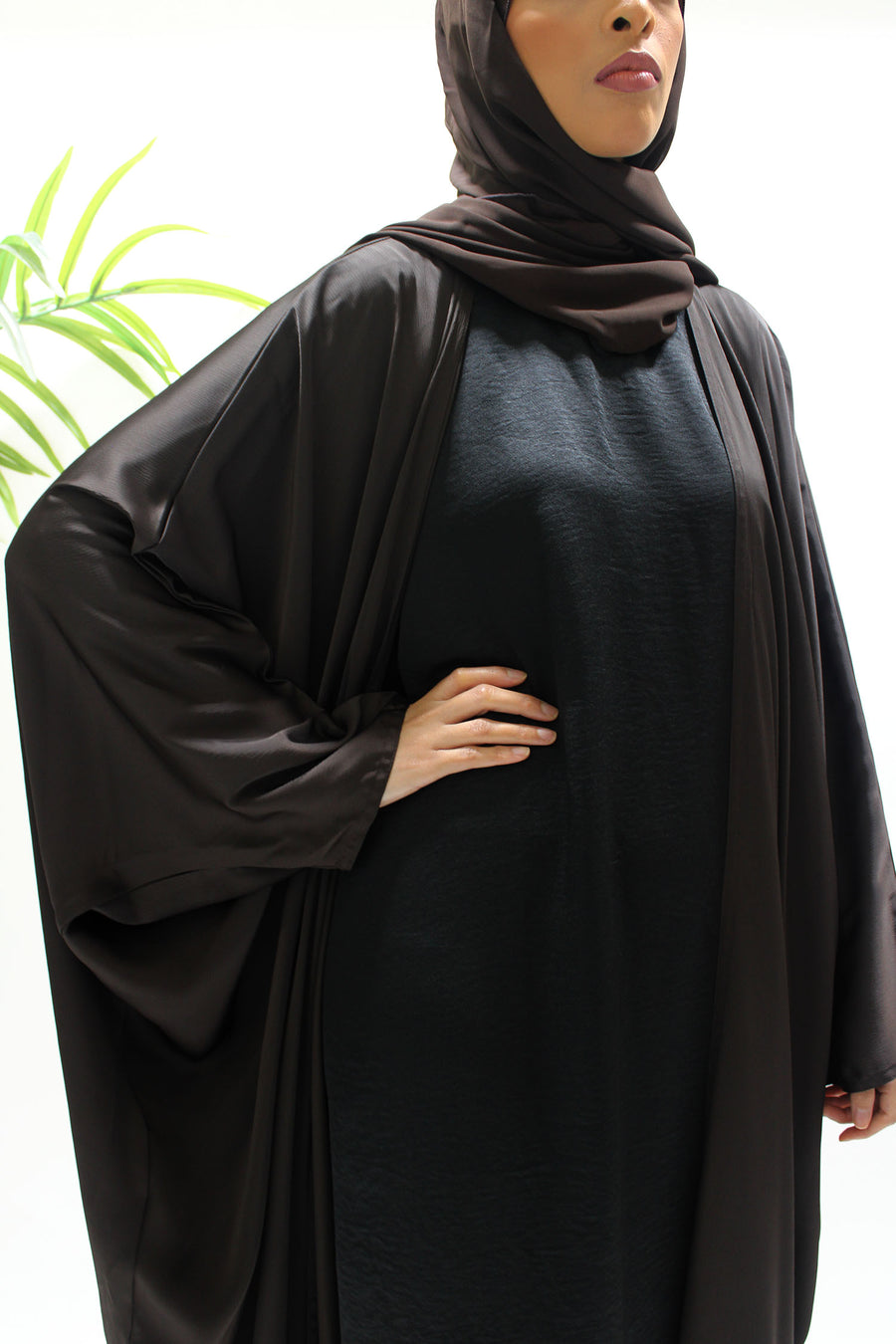 Textured satin detail on the brown farasha abaya