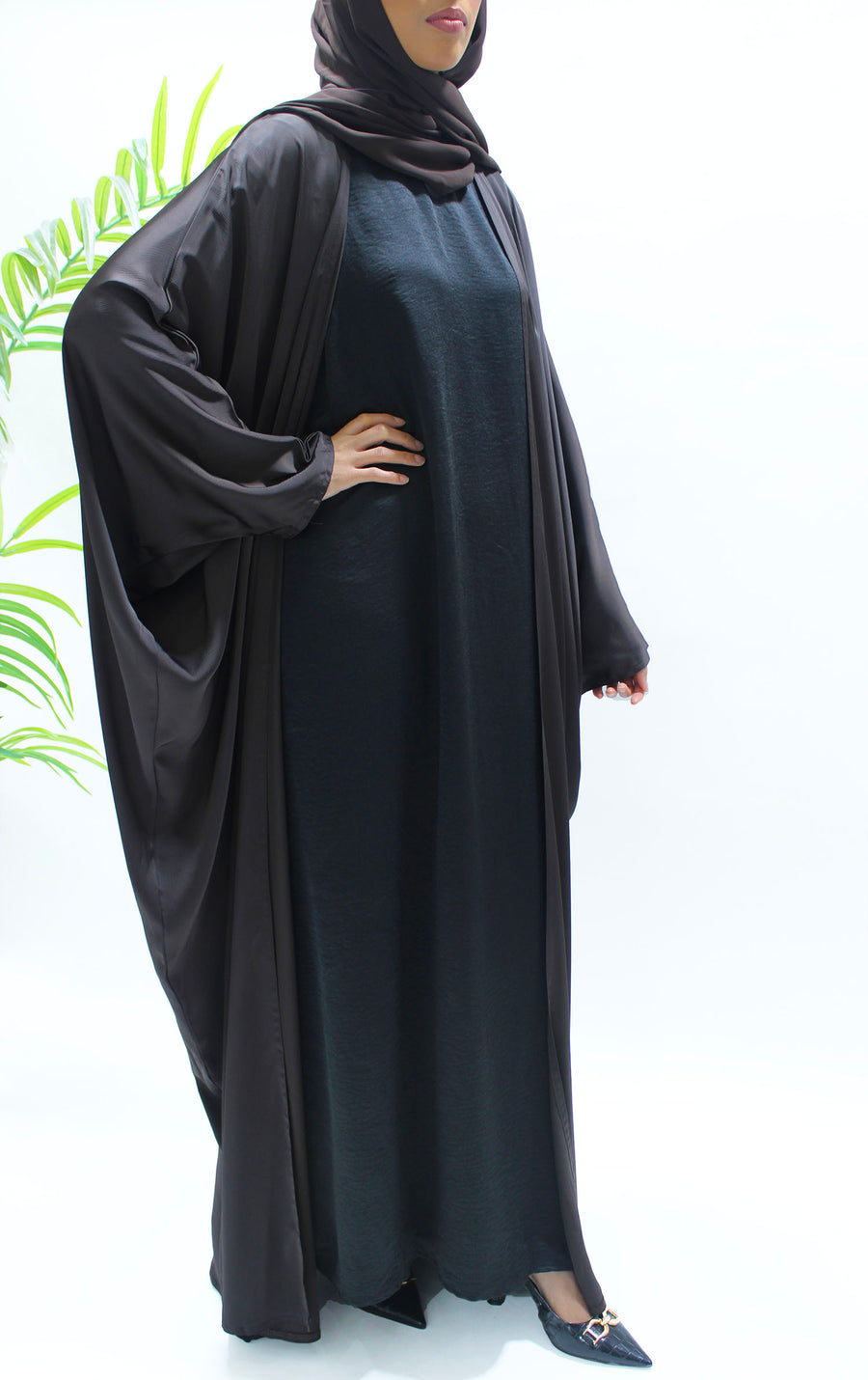Full-length view of Amani's brown farasha abaya set