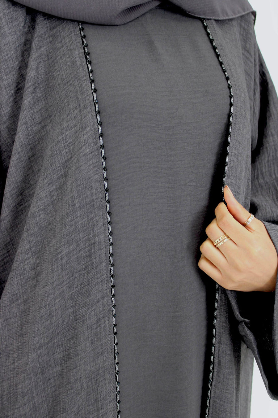 Full-length view of Amani's charcoal grey open abaya set