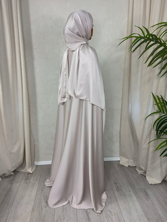 Detail of the nude three-piece abaya set in soft Armani satin with matching scarf