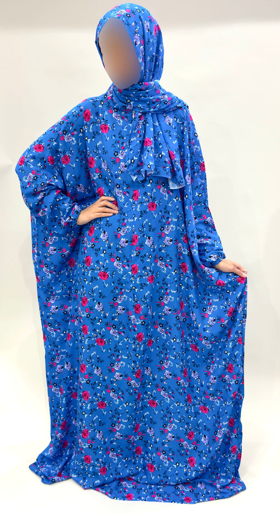 Bright blue floral prayer dress showing the attached hijab