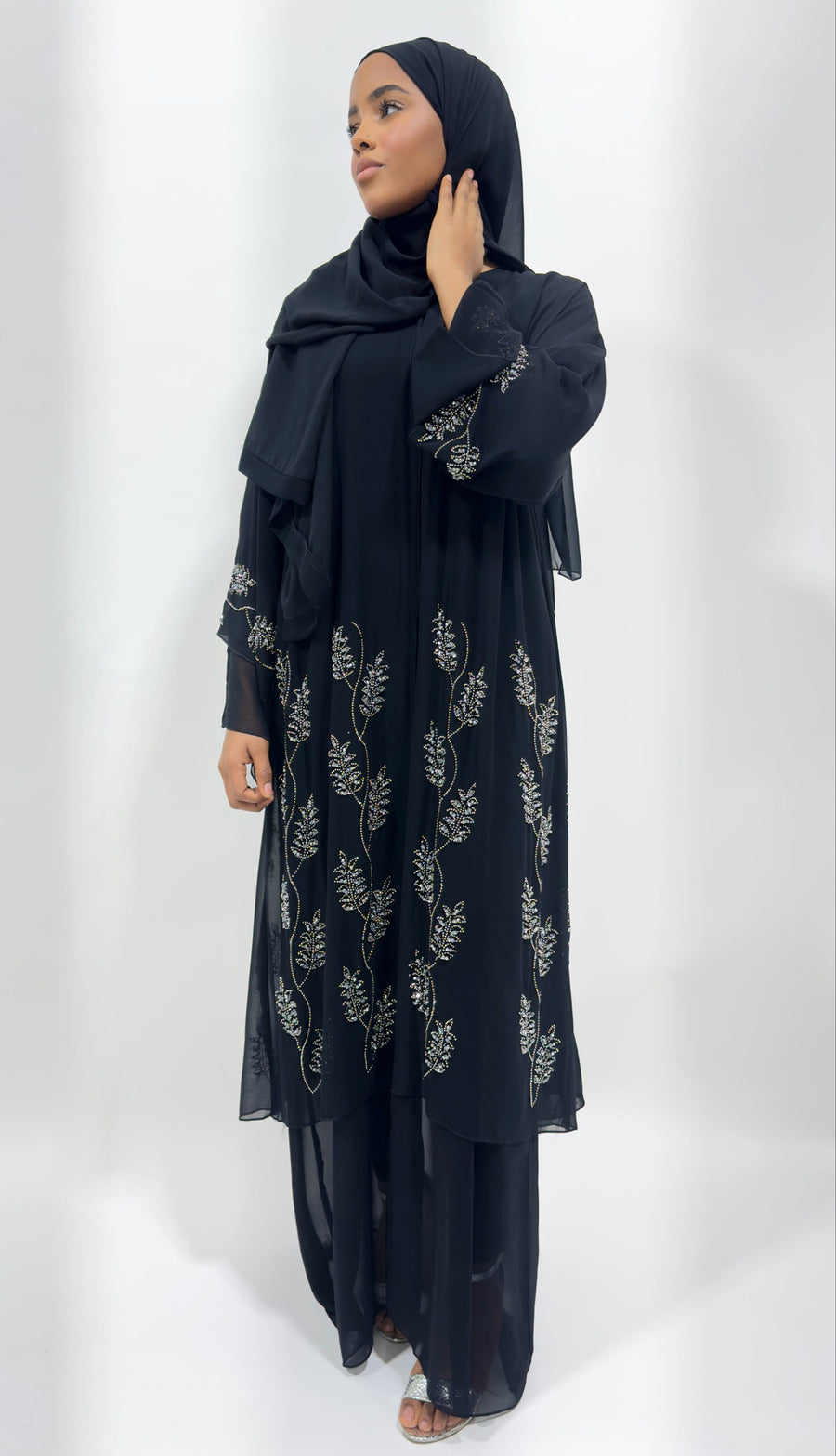 Woman wearing Amani's black double chiffon embellished open abaya
