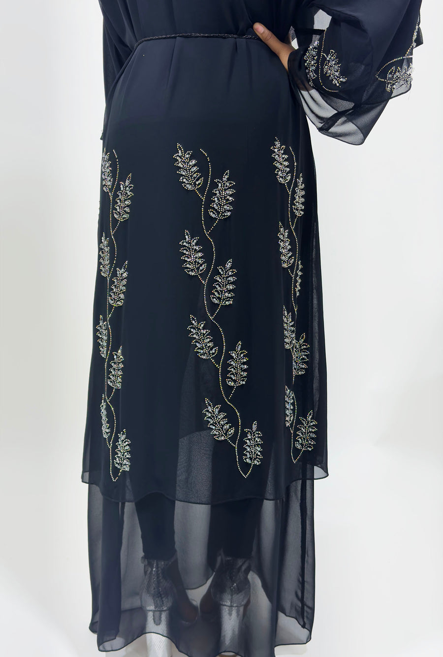 Full-length view of Amani's black double chiffon open abaya
