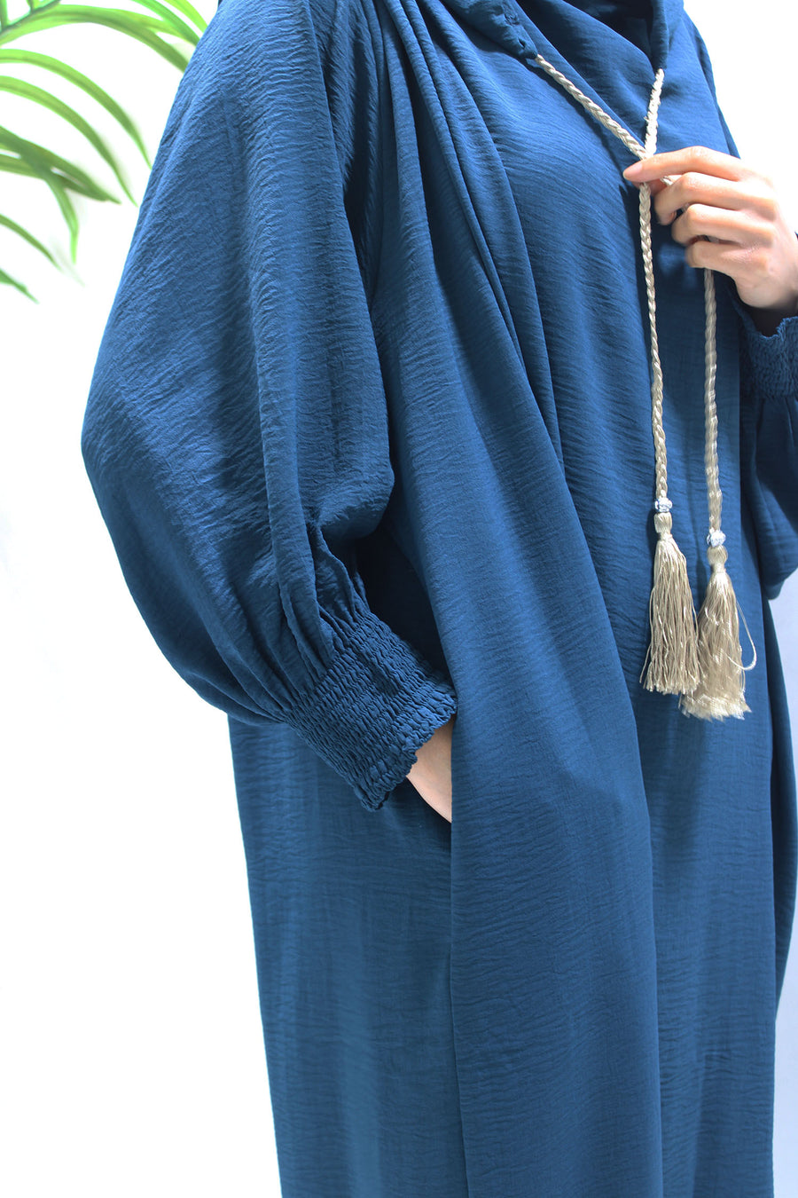 Teal prayer abaya showing the ruched cuffs for wudu