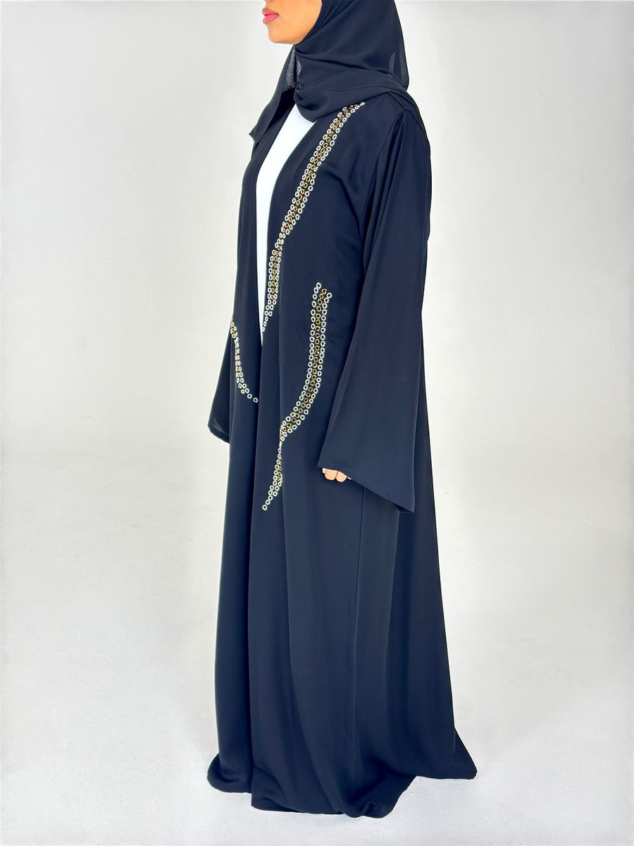 Gold and silver embellishment on the black duster abaya