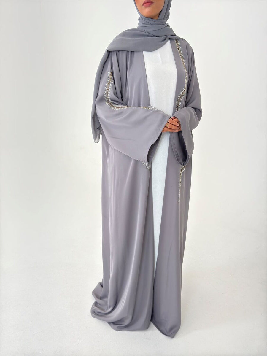 Full-length view of Amani's grey duster style abaya