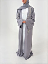 Woman wearing Amani's embellished grey duster style abaya with scarf