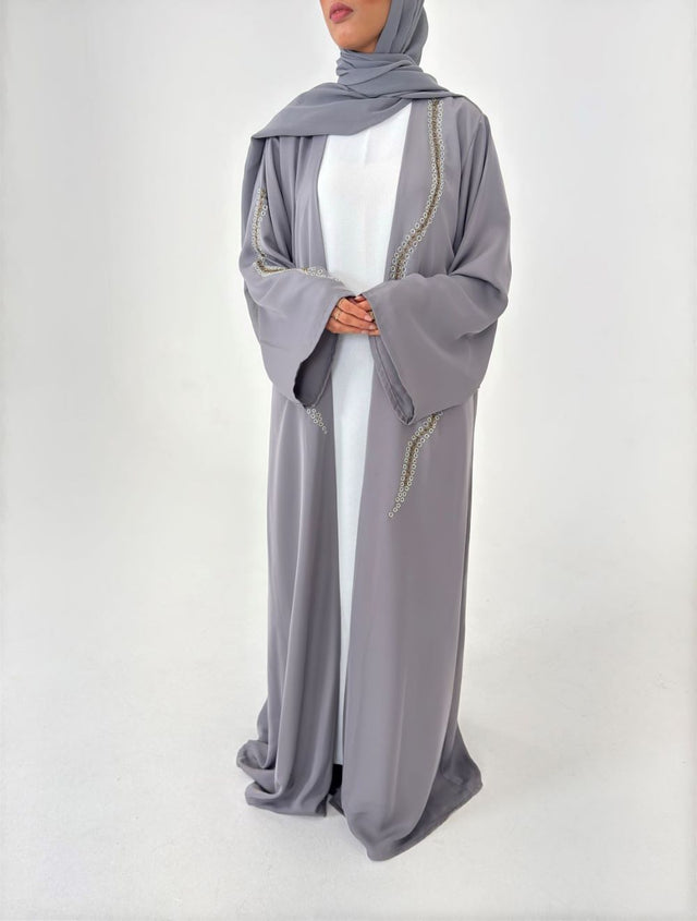 Woman wearing Amani's embellished grey duster style abaya with scarf