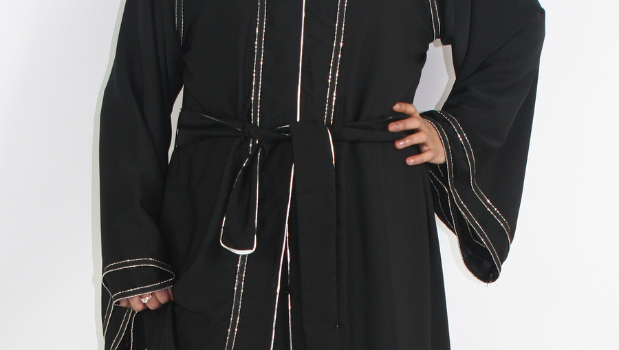Detail of the silver-lined border on the open abaya