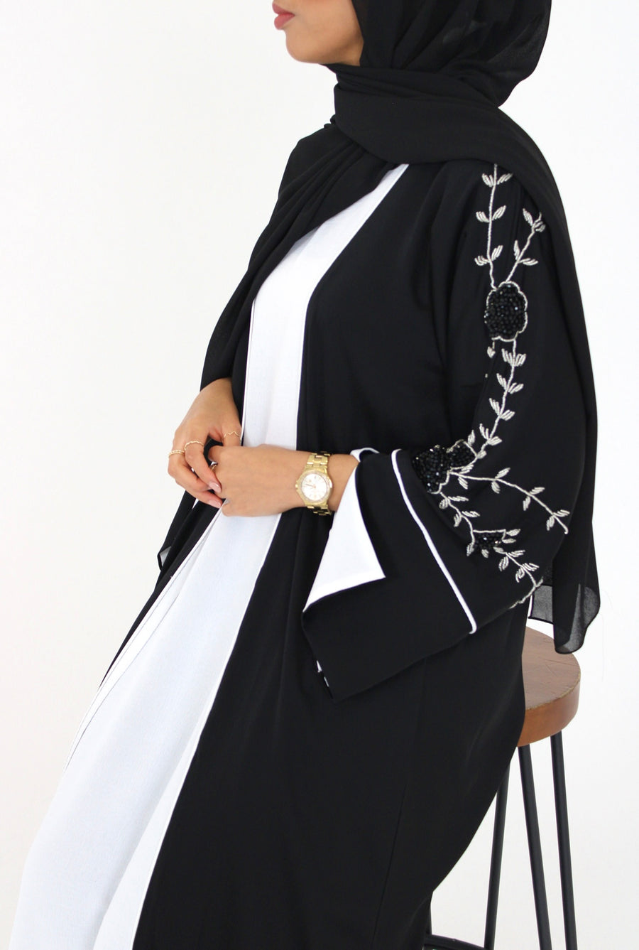 Full-length view of Amani's black floral embellished abaya set