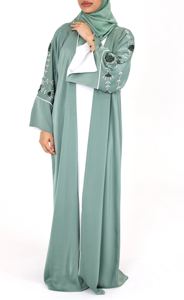Woman wearing Amani's topaz green floral embellished open abaya set